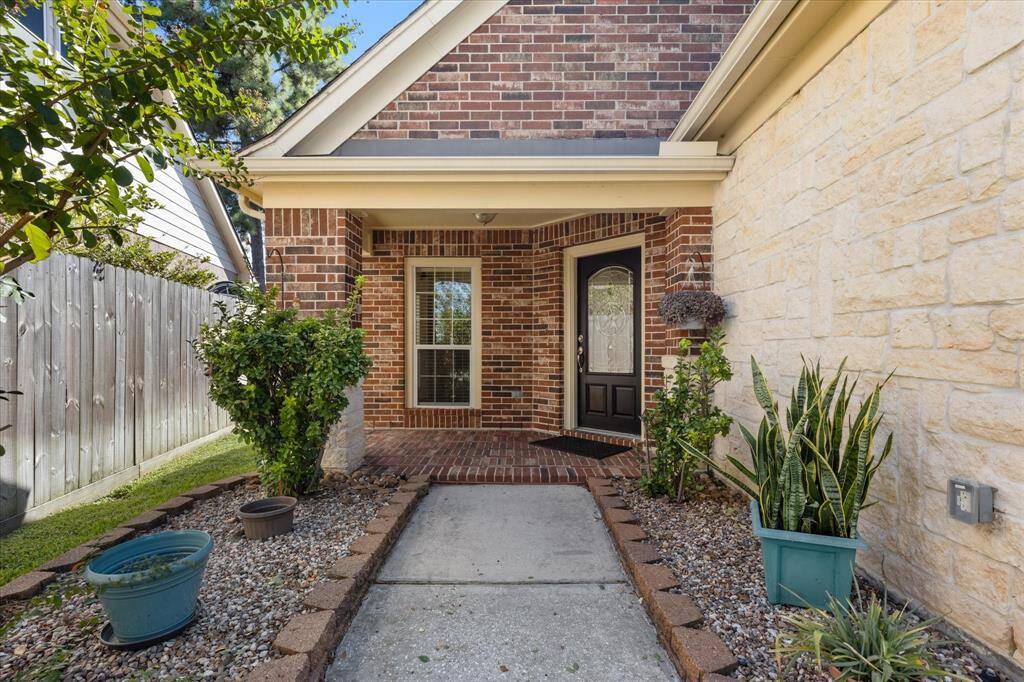 Beautiful Brick, Stone Home with a welcoming covered porch.