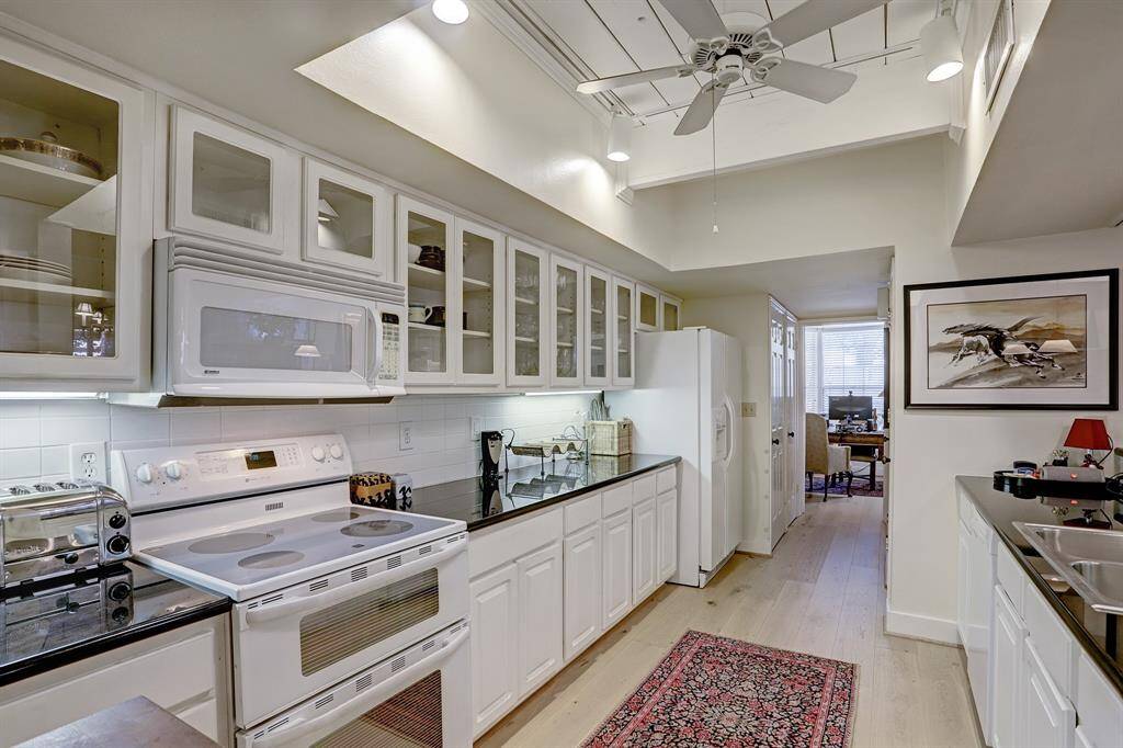 Granite Kitchen with white cabinets.