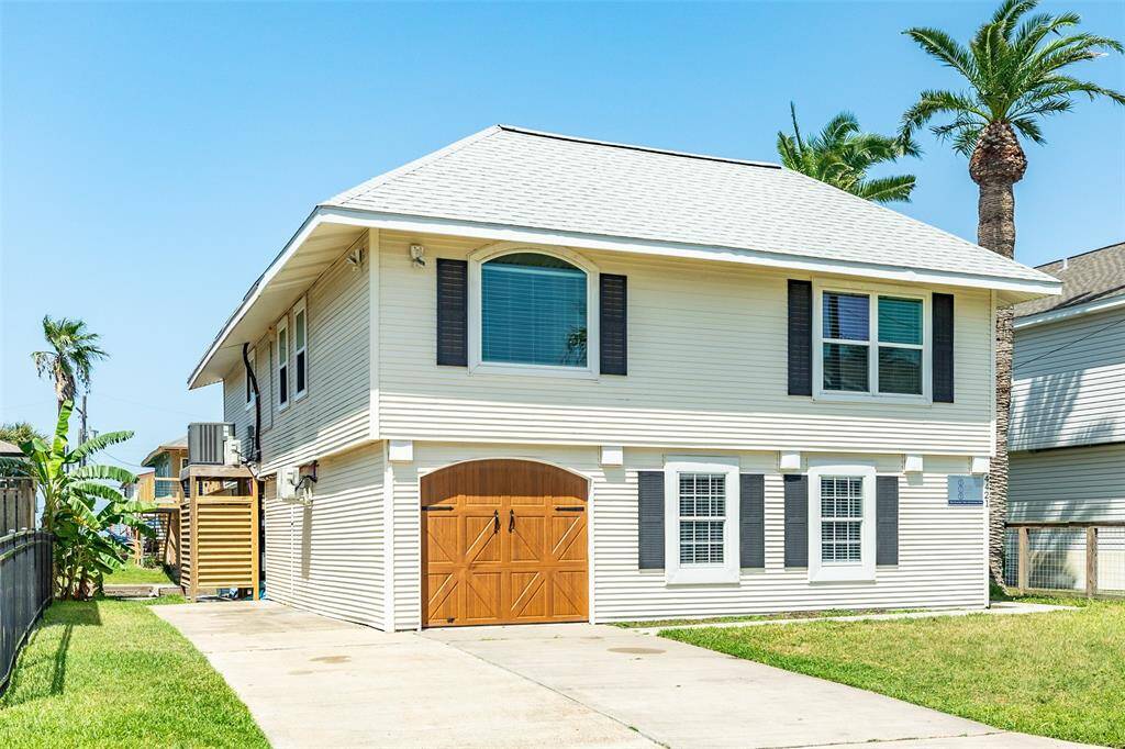 Front of home with large double-wide driveway and extended parking