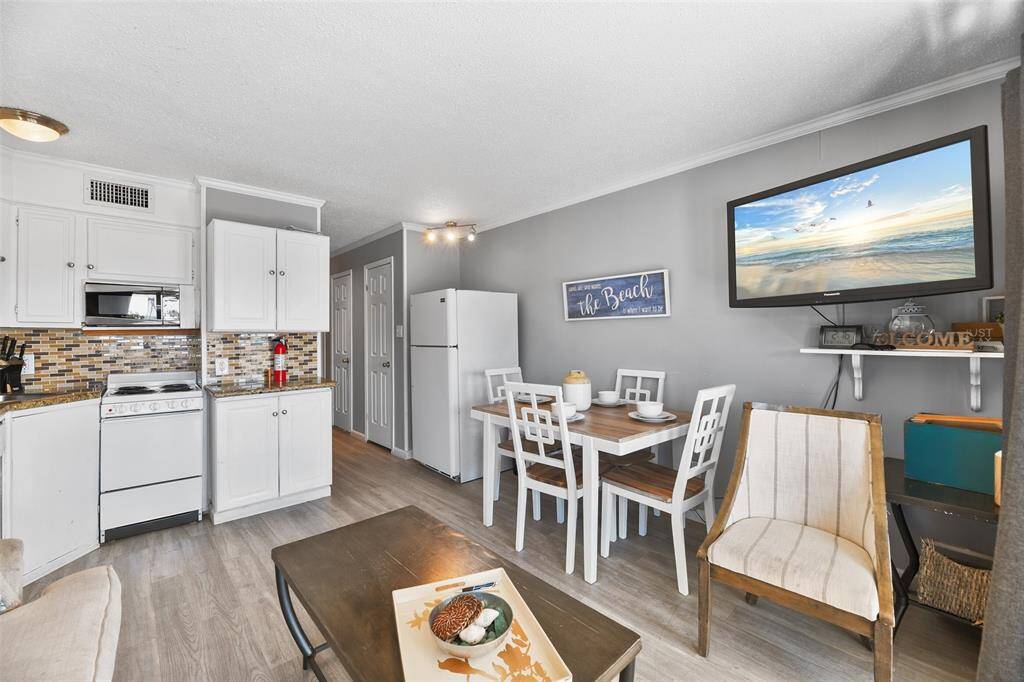 Enjoy the seamless flow of this open-concept living and kitchen space, perfect for relaxing after a day at the beach.