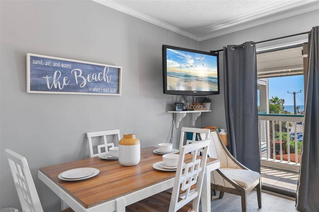 Tucked within the shared living space, this charming dining area is perfect for enjoying meals while taking in the gulf breeze from your patio.