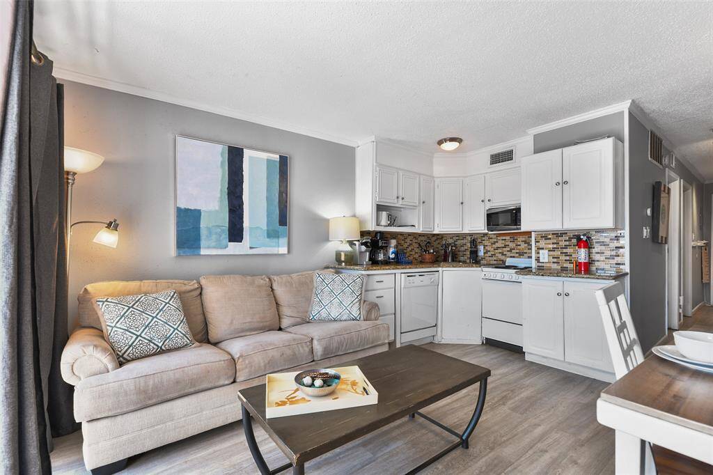 Whether you're cooking or lounging, this space offers a light, airy feel with a stunning beach view just steps away.