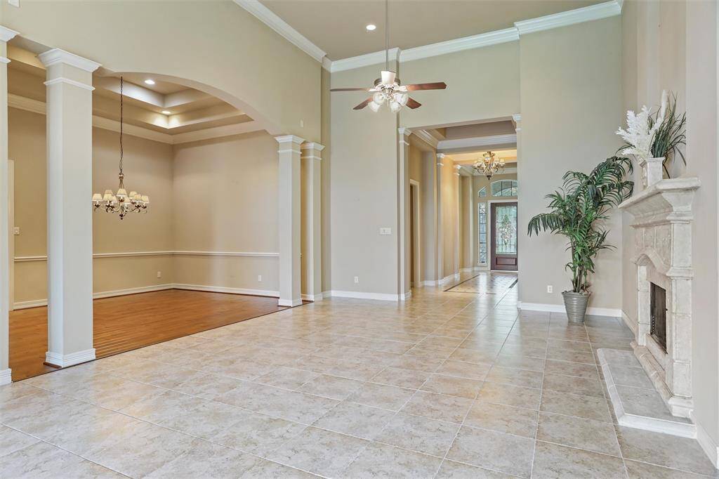 Experience seamless entertaining in the dining area, featuring elegant tray ceilings that enhance the room's spacious feel, right off the living room.