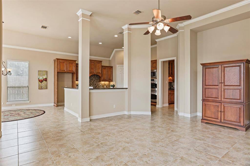 Experience the heart of the home in this inviting kitchen, designed for seamless entertainment and family engagement. Whip up culinary delights without missing a moment of the game or your children's playtime.