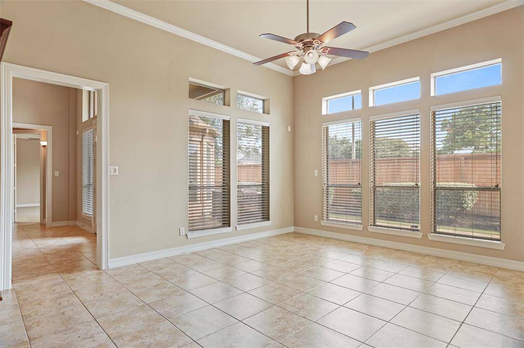 Enjoy the expansive view from the den's floor-to-ceiling windows, offering ample natural light and a seamless connection to the outdoor entertainment space.