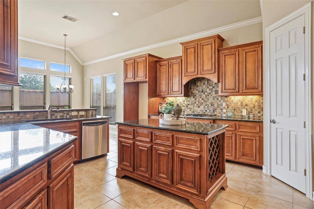 Experience culinary delight in this spacious kitchen, boasting ample cabinetry and sleek granite countertops.