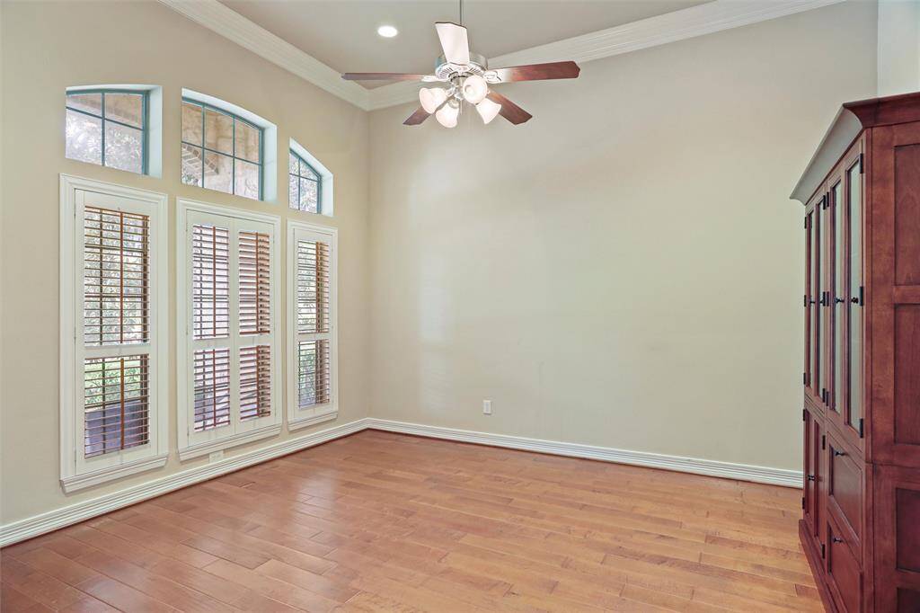 Enjoy serene views of a majestic oak and the charm of a front porch from the comfort of this sunlit study.