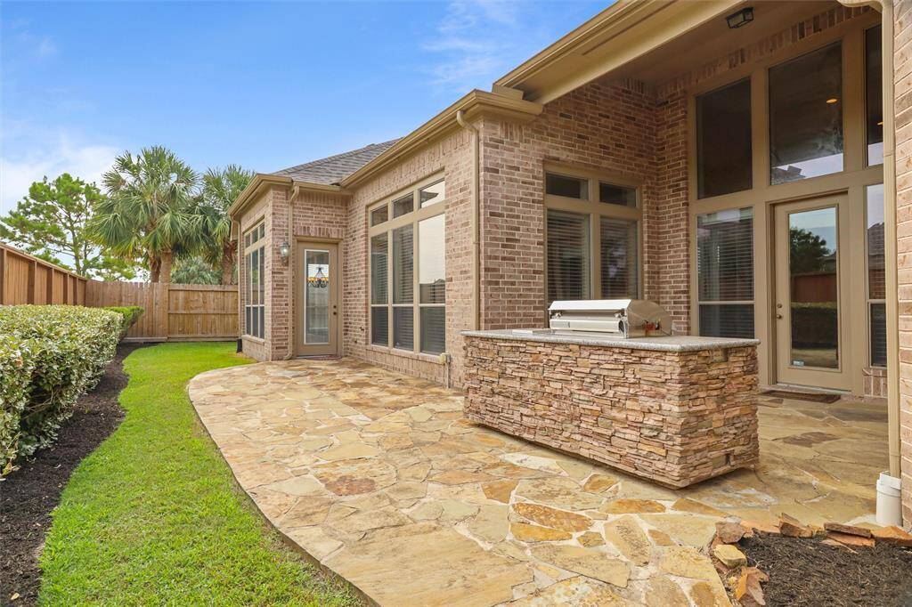 Step outside from either the breakfast nook or living area onto a charming flagstone patio with a covered space, perfect for outdoor relaxation and entertaining.