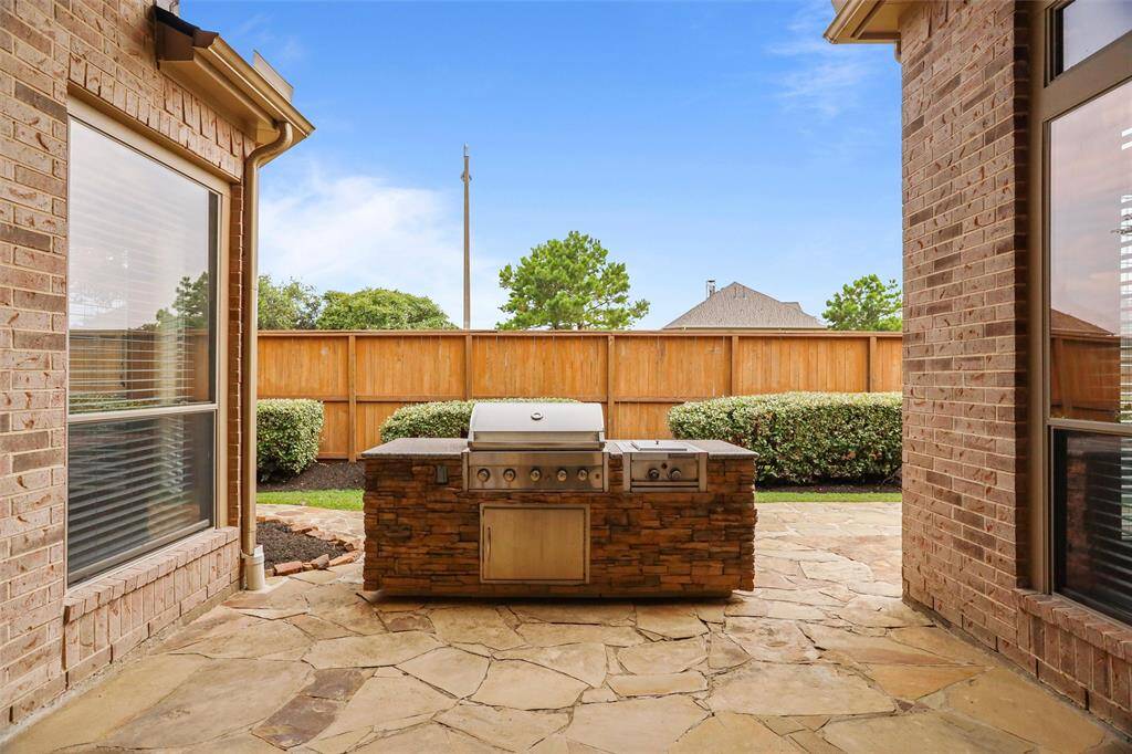 Experience alfresco dining at its finest with this fully-equipped outdoor kitchen, perfect for entertaining and enjoying the comfort of your backyard.
