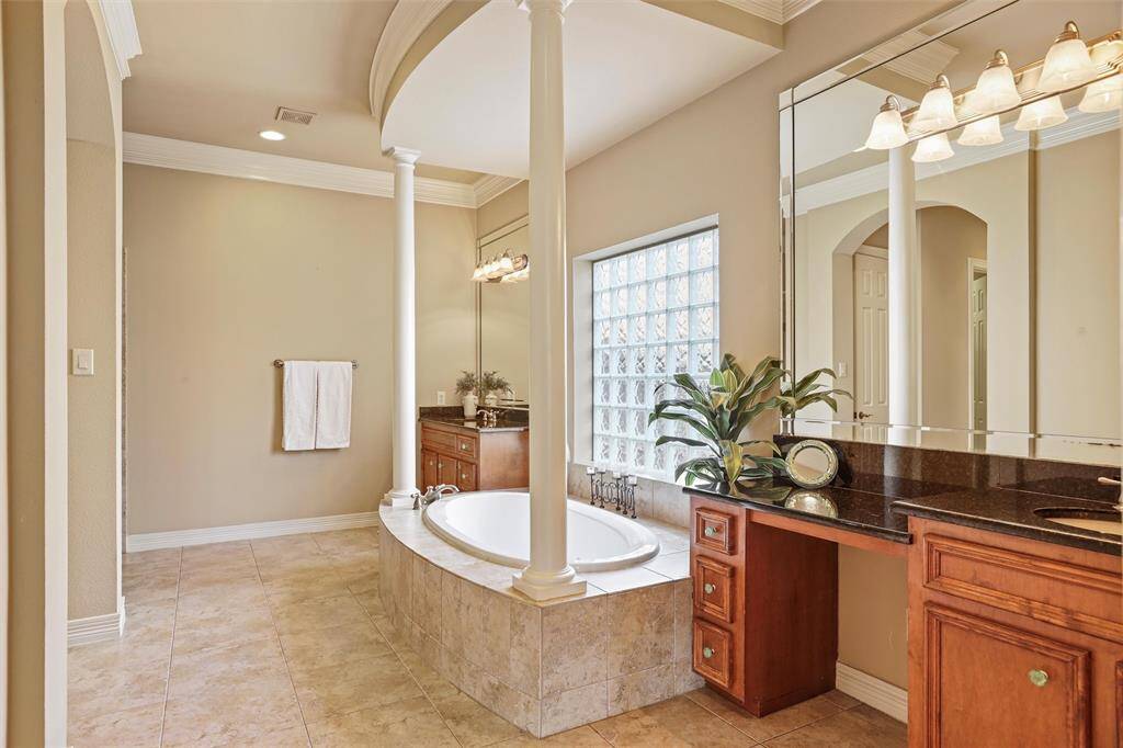 Indulge in the luxury of the primary ensuite, boasting dual vanities and a spacious walk-in shower for a serene spa experience at home.