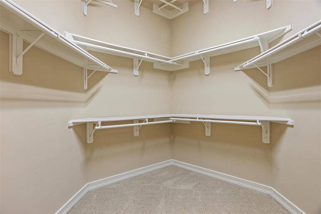 Explore the spacious walk-in closet, one of a pair complementing the master suite, designed for ample storage and organization.