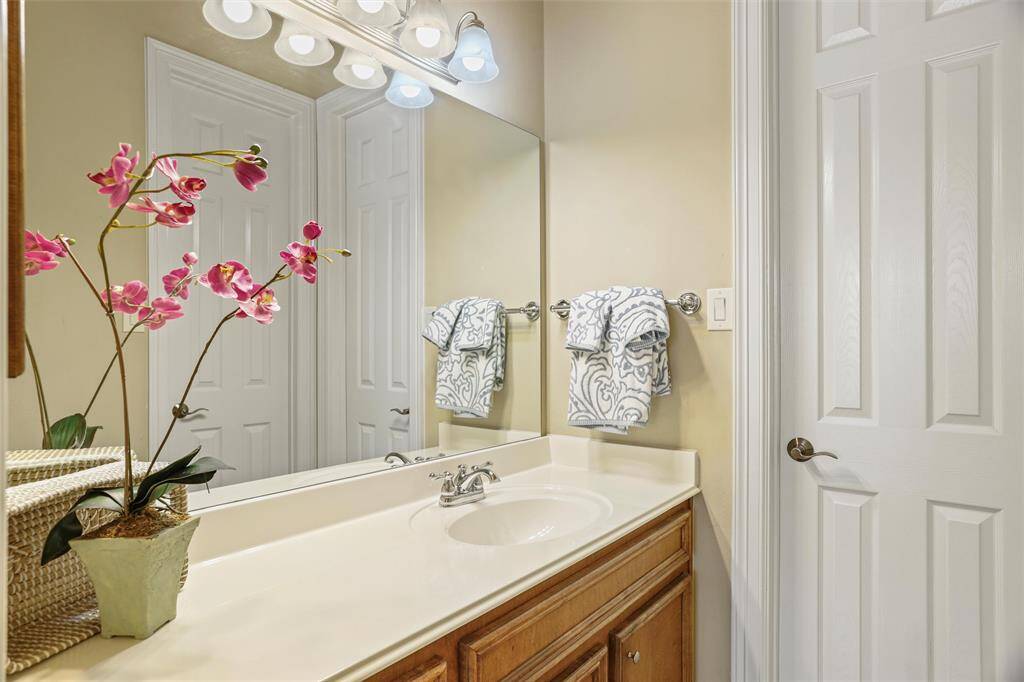 Charming third bathroom with elegant fixtures and ample lighting.