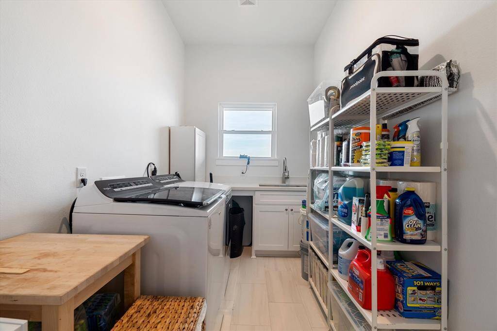 Oversized laundry room with sink