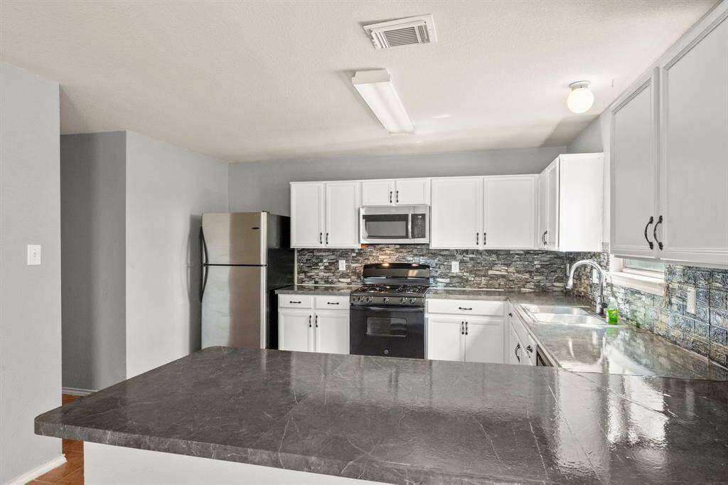 Stainless Refrigerator Stays.  Gas Stove.