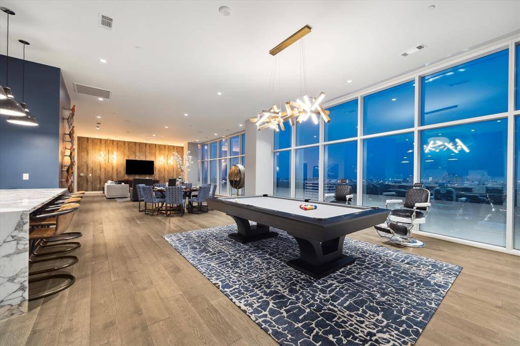 Floor-to-ceiling windows frame the cityscape, making this living room truly exceptional