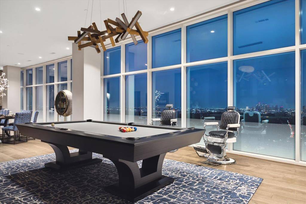Sophisticated entertainment lounge with panoramic views of the Houston skyline.
