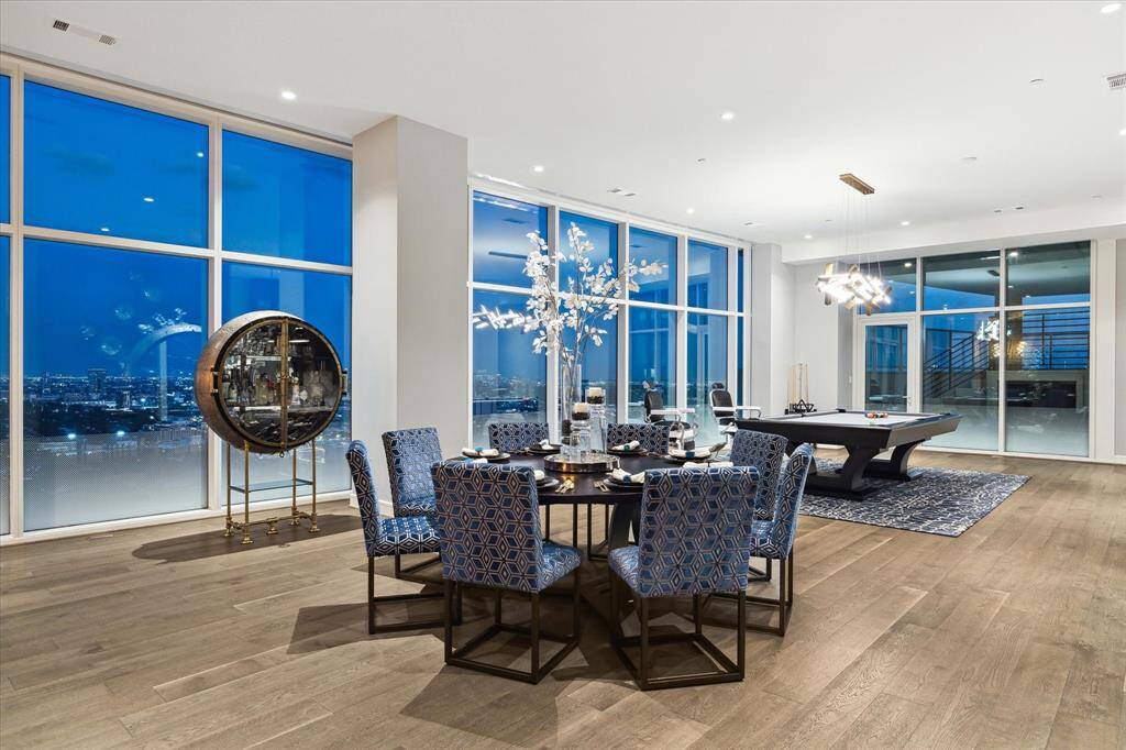 Elegant dining space with panoramic views, perfect for family gatherings and leisure with a stylish pool table.