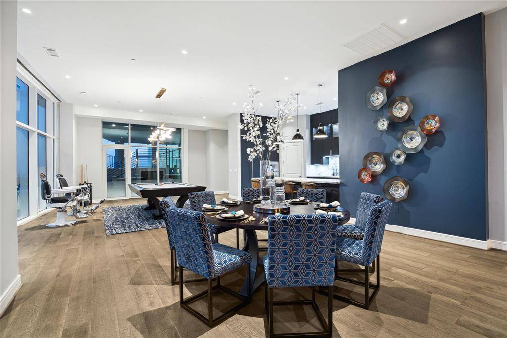 Explore the seamless elegance of this open-concept living space, perfect for entertaining and relaxation, highlighted by a striking accent wall and abundant natural light.