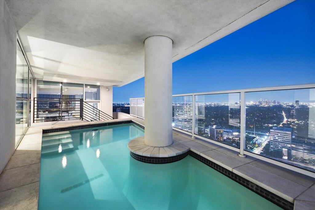 Elegant poolside oasis with panoramic city views, perfect for sophisticated entertaining.