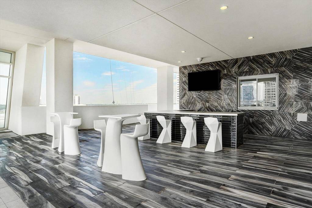 Exclusive building amenity: sleek indoor pool lounge.