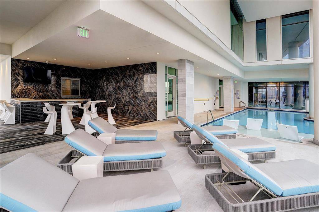 Spacious indoor pool oasis with luxurious seating options.