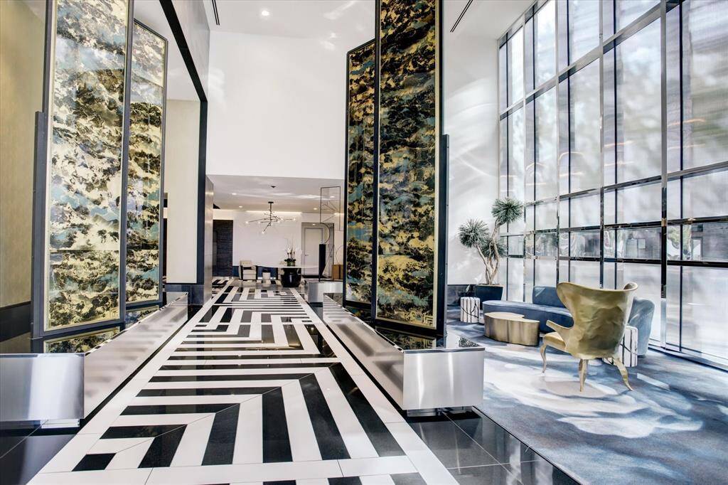 Elegant Entrance Hallway: Step into luxury with this sophisticated lobby, showcasing high ceilings, striking geometric flooring, and abundant natural light.