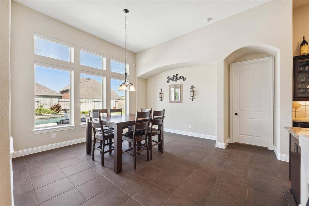 Large breakfast room/dining room with nook that could easily house additional cabinetry, wet bar, dry bar or a china hutch.