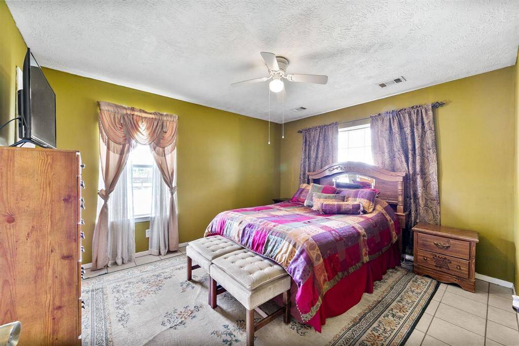 Primary suite is bathed in natural light, offering a bright and serene atmosphere. It features a private ensuite bathroom, providing a convenient retreat.