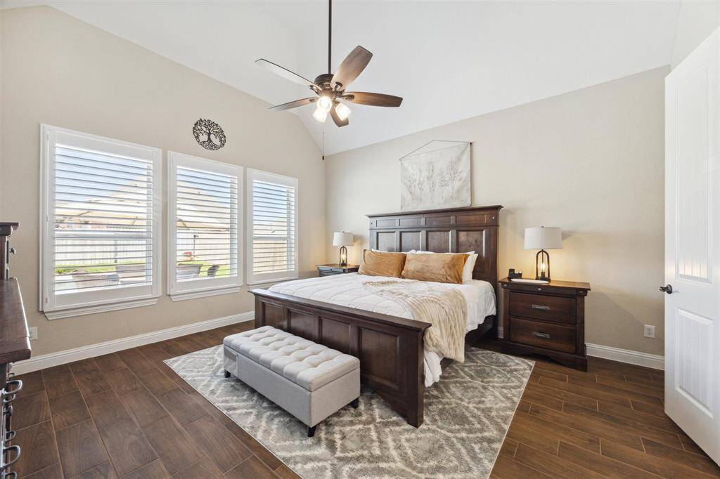 Primary bedroom with updated tile flooring.