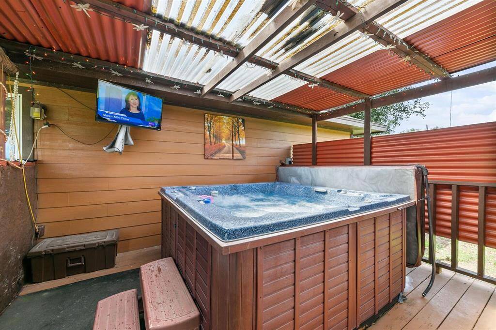 The partitioned section houses a hot tub, creating a private and cozy retreat for unwinding in comfort.
