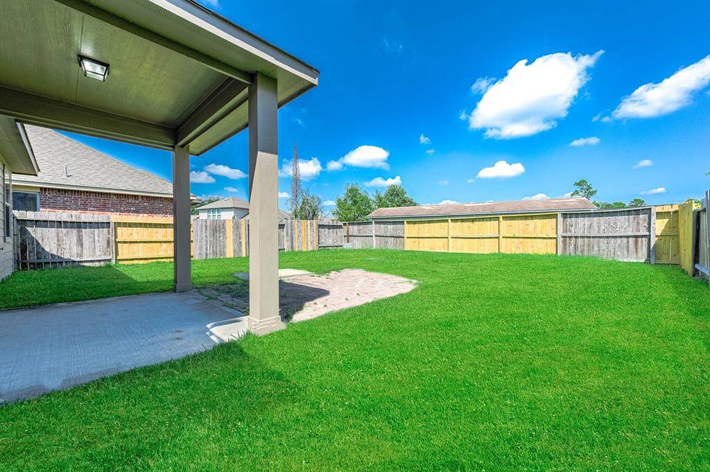 Covered patio in the fully fenced backyard. Virtually ENHANCED