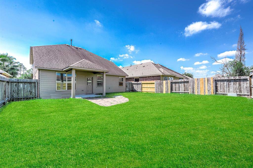 Covered patio in the fully fenced backyard.Virtually ENHANCED