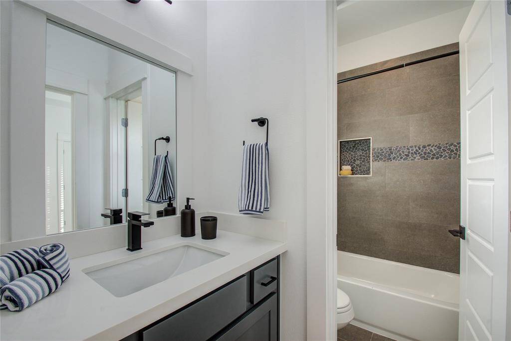 J&J bathroom with access to the secondary bedrooms. Model home photos, finishes and floor plan MAY VARY! Ceiling fans are NOT INCLUDED!