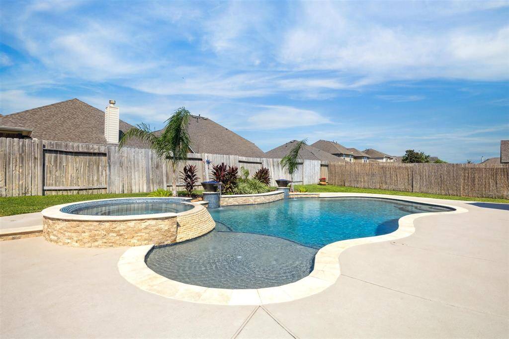 Tanning ledge with bubblers, umbrella holder, steps down, wrap around bench on both sides of the pool.  Color changing lights at night.