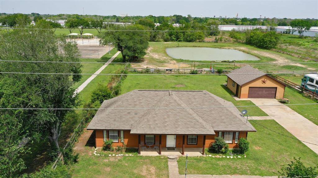 The property features an inviting pond, perfect for fishing and outdoor activities, along with plenty of open space for relaxing or entertaining.