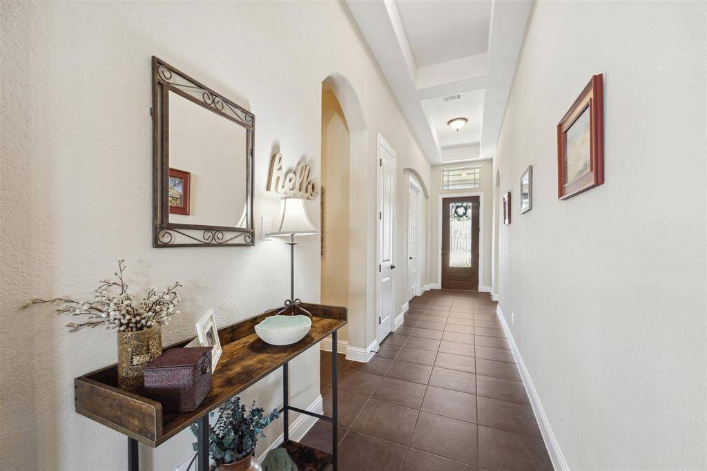 Tray ceilings accent this beautiful hallway.