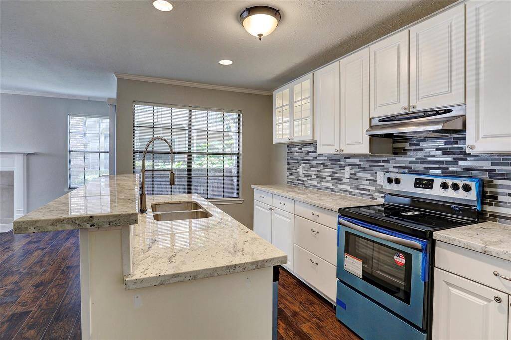 Fully updated kitchen with light granite countertops and stainless steel appliances