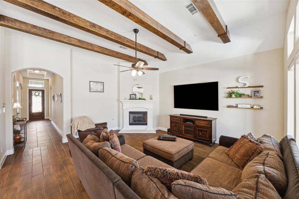 Wooden ceiling beams, corner  gaslog fireplace, spacious living room, automatic (remote operated) shades in the living and breakfast room.