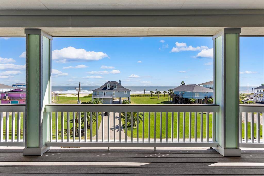 Beautiful ocean view from a spacious 2nd floor deck, framed by elegant railings.