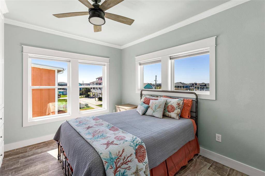 2nd floor bedroom with large double pane windows offering ample natural light and neighborhood views.
