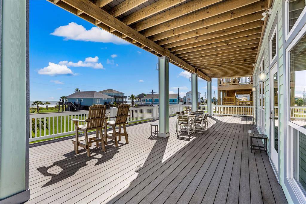 A spacious, covered Trax deck with outdoor furniture, offering a scenic beach view. Ideal for relaxation and entertaining, with plenty of room for seating and enjoying the outdoor.