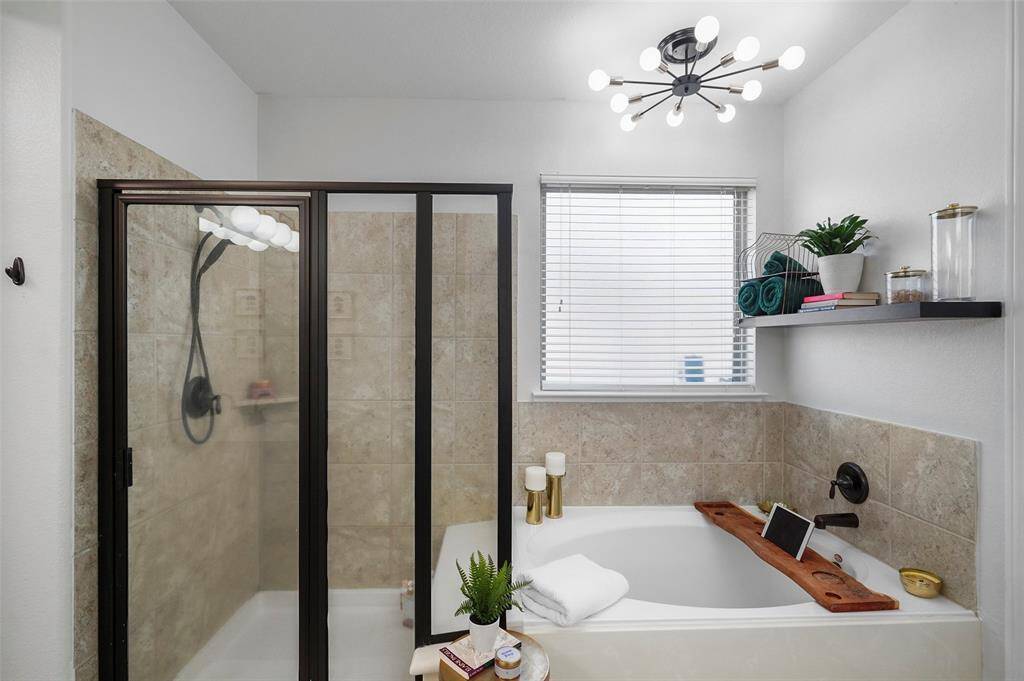Separate shower and soaking tub in the primary bath.
