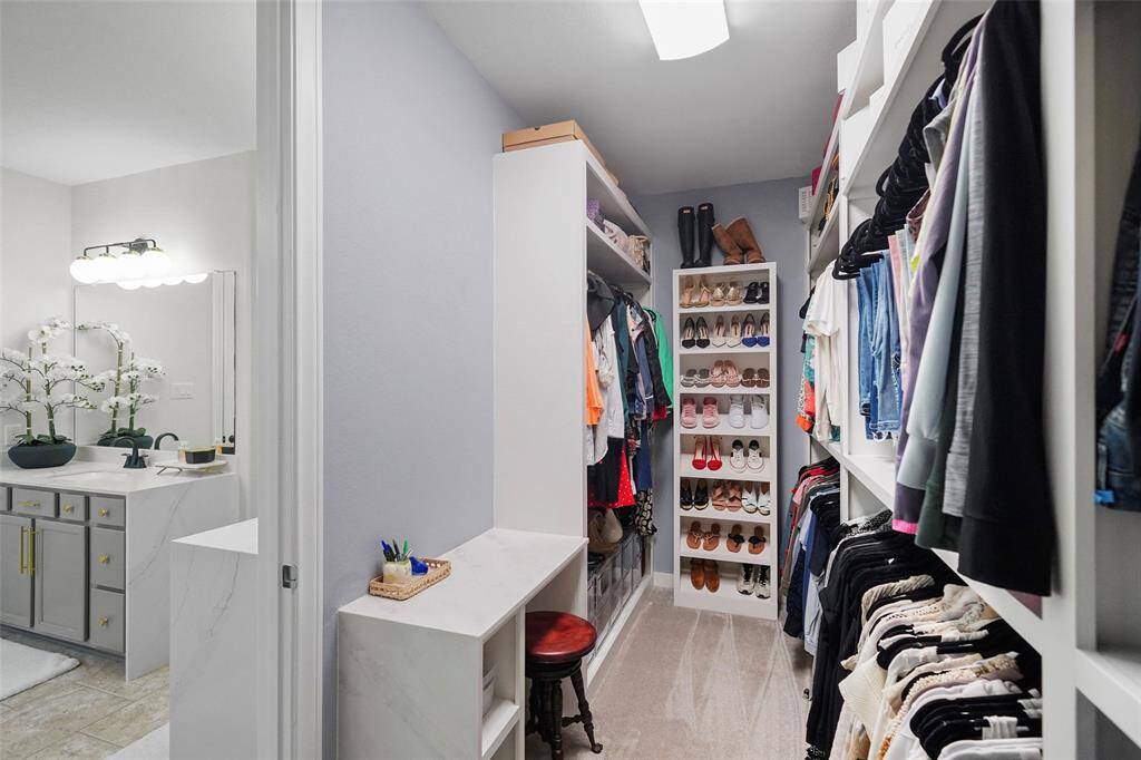 The primary closet is large with built-ins for storage.