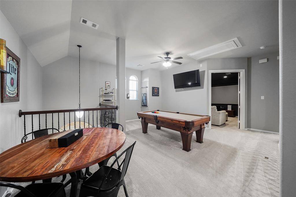 At the top of the stairs is a large open space which could be used as a game room or playroom. This space overlooks the entry foyer and living room.