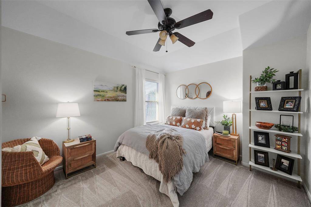 A second guest bedroom with neutral paint, carpet and connects to the jack and jill bath.