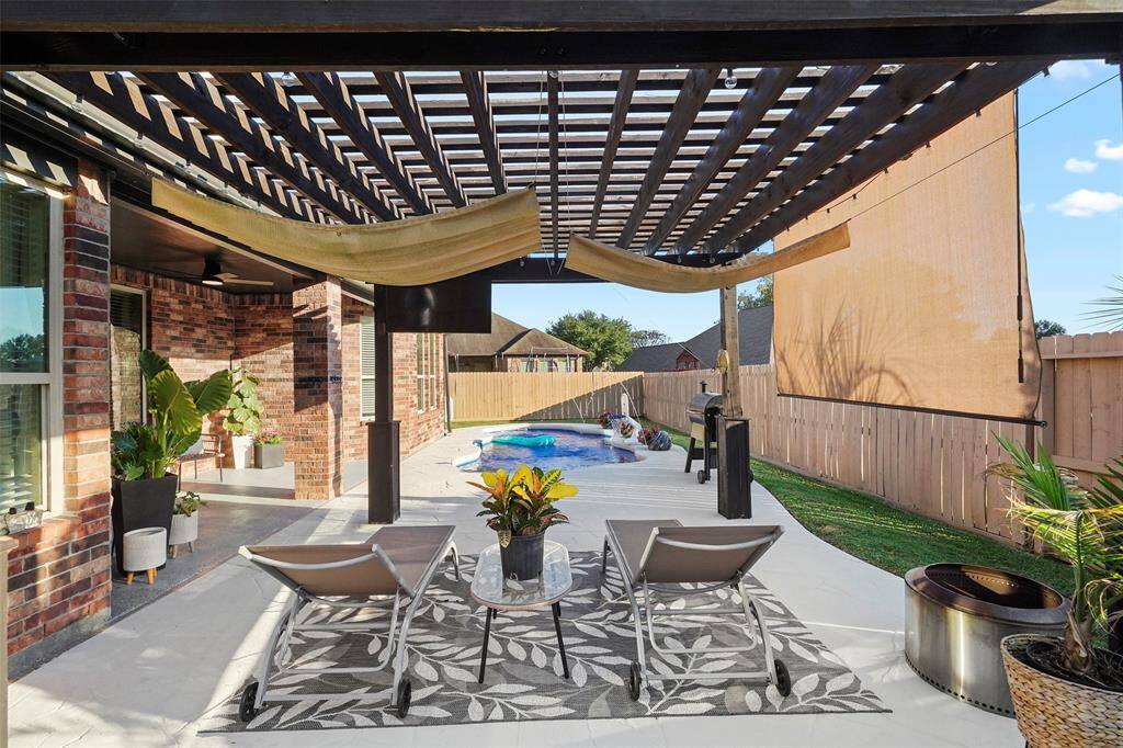 Enjoy your own backyard paradise with this salt water pool and covered pergola area.