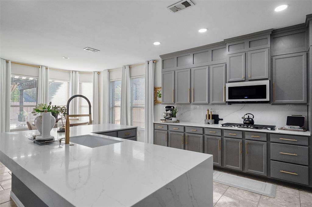 Large island with additional seating space. The waterfall edge on the island adds a modern element and focal point to the kitchen.