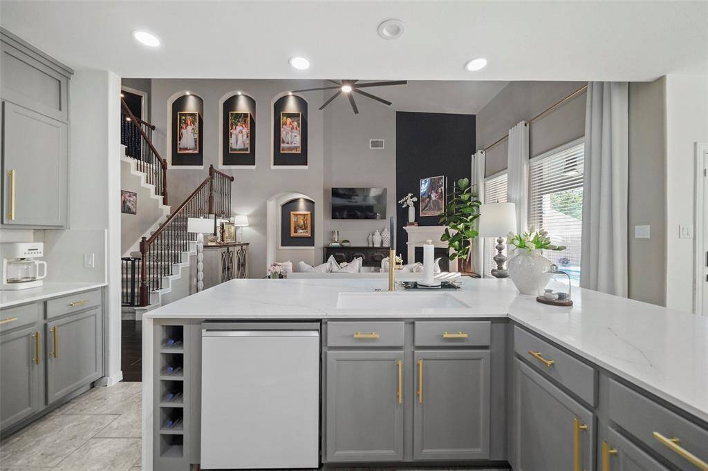 Dishwasher, large basin sink, wine/bottle storage and cabinet storage complete this island.