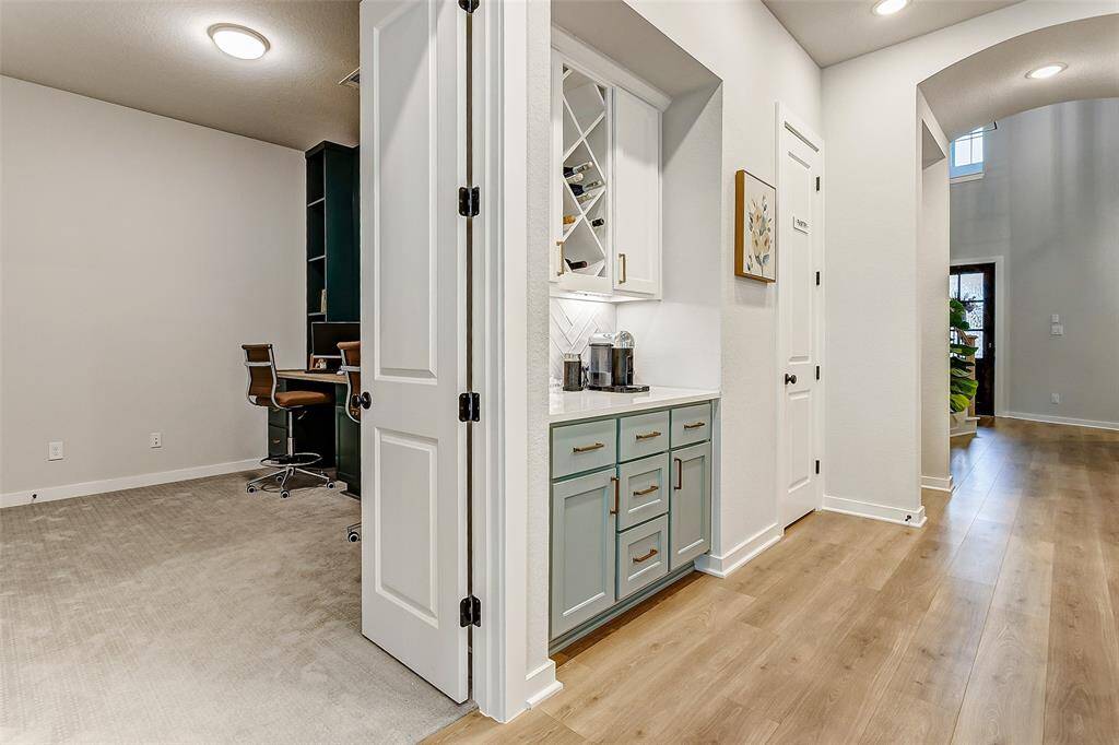 This home has a bonus office, study, home gym, or media room right off the kitchen.