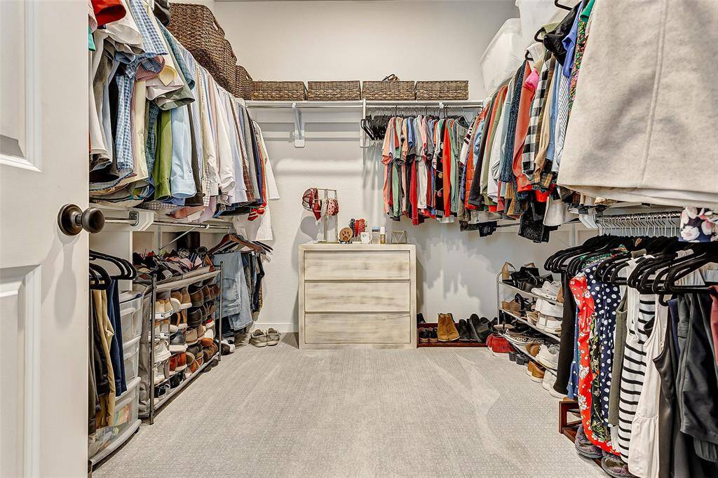 The primary suite offers a large walk in closet with built in shelving and tons of storage for your wardrobe.